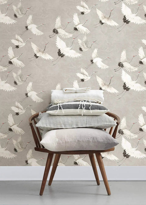 Halcyon Peel And Stick Grey And White Crane Pattern Wallpaper Removable Contact Paper For Walls behind a modern chair with cushions.