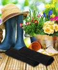 Badass Cut Resistant Arm Sleeves Black Anti Cut Wrist Guards 2 Pack positioned next to blue gardening boots and flower pots.