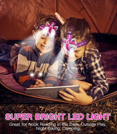 Children using Unicorn Themed LED Headlamp For Kids And Grownups, Hands Free, 2 Bright LEDs, 3 Adjustable Lighting Modes in a tent