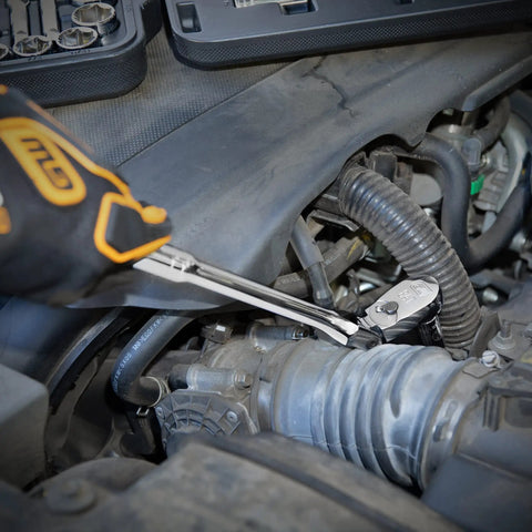 Mechanic using 4 Piece Flex Handle Ratchet Set with 84 Tooth Ratchets in engine bay, demonstrating easy access in tight spots
