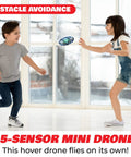 Kids playing with Hand Operated Scoot Drone For Kids And Adults With Hands Free Motion Sensor LED Indoor UFO Toy Rechargeable Flying Orb Ball Drone For Boys And Girls Blue Easy Toss To Launch And Hover For Beginners indoors.