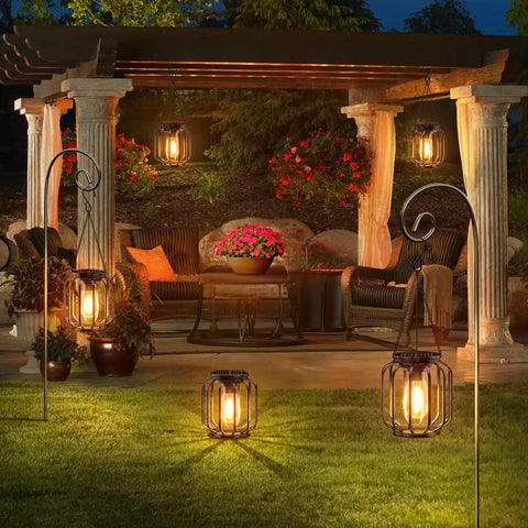 Outdoor Solar Lanterns Pack Of 4 Waterproof Metal Hanging Lights illuminating a garden patio area at night