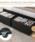Black Queen Bed Frame Featuring Integrated Led Lights And Convenient Charging Station With Two Smooth Gliding Storage Drawers showing neatly organized linens.