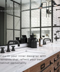 Modern bathroom with black fixtures and white marble countertop, featuring wooden cabinetry and large mirror with industrial lighting.