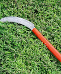 K208P Easy Grab And Go Harvest Sickle With Plastic Handle And Light Serration, lying on grass