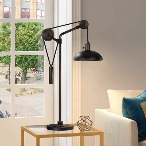 Dope 33.5 Inch Tall Industrial Table Lamp With Solid Wheel Pulley System And Blackened Bronze Metal Shade by window in living room