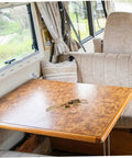 Heavy Duty Truck Latch Kit with Spring Release on a camper table inside a vehicle, ideal for securing compartments and hasps.