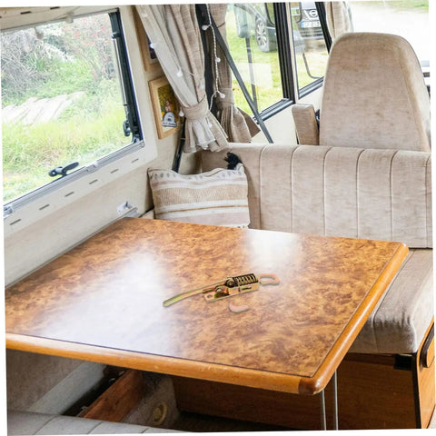 Heavy Duty Truck Latch Kit with Spring Release on a camper table inside a vehicle, ideal for securing compartments and hasps.