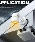 White outdoor wall-mounted spotlight with weatherproof junction box and black cable glands.