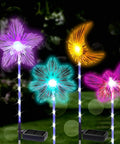 Solar Garden Stake Lights 4 Pack With RGB Color Changing LEDs For Pathways And Outdoor Living, glowing in garden at night