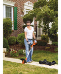Person using 3 In 1 Cordless Weed Eater Lawn Edger And Lawn Mower with Two Batteries and Charger, 12 inch battery powered, on lawn