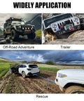 Heavy Duty 13800 Lbs Electric Winch For Trucks, UTVs And Offroad Vehicles With Steel Cable, 12V Power towing a stuck vehicle in muddy terrain.
