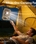 Person using remote control for Portable 6 Inch Folding Fan With 20000mAh Battery Built-In Power Bank LED Light in camping tent