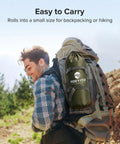 Hiker carrying a backpack with 17x10 Ft Heavy Duty Camping Tarp Rain Fly With PU6000mm Waterproof Coating in pouch, outdoor scenery