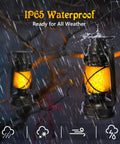 Bronze Vintage Solar Lanterns Two Pack Outdoor Lights with LED in rain showcasing waterproof feature, hanging on tree.