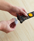 Hands holding Advanced Water Filter Cartridges For 12-Cup Programmable Coffee Makers, 2 Pack White, for installation.