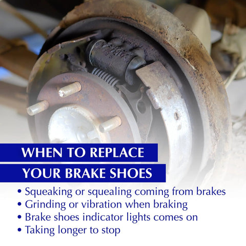 Rear drum brake shoe set installed on a rusty hub and brake drum assembly, with wheel studs visible.