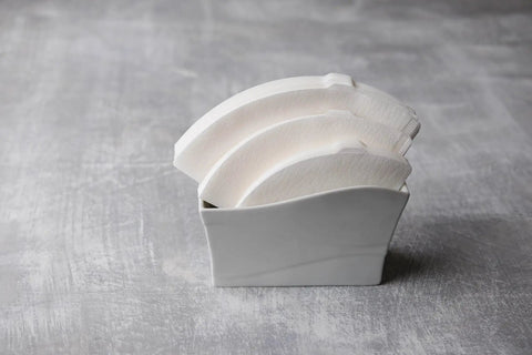 V60 Cone Pour Over Coffee Filters Size 02 White 600 Count Unbleached Single Use Paper Filters displayed in a holder