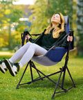 Woman relaxing in a Hammock Camping Chair With 3 Height Settings And Headrest Portable Adjustable Backrest in a garden setting.