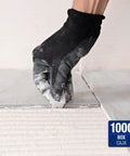 Gloved hand using LASH Tile Leveling System Part A Clips For One Sixteenth Inch Grout 1000 Pack to align floor tiles