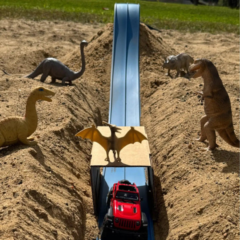 Classic 15-Foot Race Track Starter Set With 2-Lane Wide Track, 2026 Upgrade, red car on blue track, dinosaur toys on sand