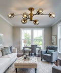 6-Light Sputnik Gold Ceiling Light Fixture With Glass Globe in living room with tufted ottoman and armchairs, mid-century style