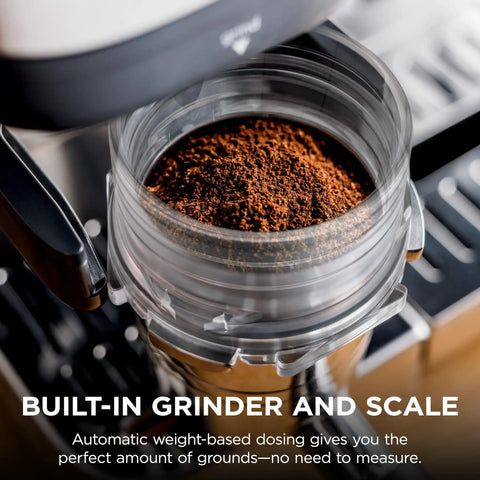 Close-up of Luxe Café Premier 3 In 1 Espresso Machine With Built In Grinder Drip Coffee And Rapid Cold Brew Hands Free Milk Frother Assisted Tamper For Cappuccinos And Lattes Stainless Steel showing coffee grounds in grinder.