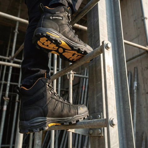 Person wearing 6 Inch Waterproof Steel Toe Work Boots For Men Leather Lace Up EH Rated Slip Resistant Outsole climbing ladder