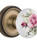Classic Rosette With Rose Porcelain Door Knob Privacy Lockset In Antique Brass, 2 3/8 Inch Backset, floral design