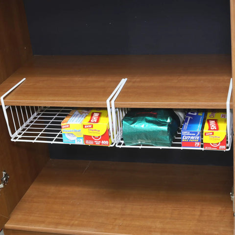Hella Versatile Two Pack Under Shelf Wire Baskets White Metal Drop Down Organizers holding kitchen supplies in a cabinet.