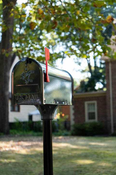 Coolidge Galvanized Steel Mailbox Post in Black for Outdoor Use with standard mailbox in a yard setting