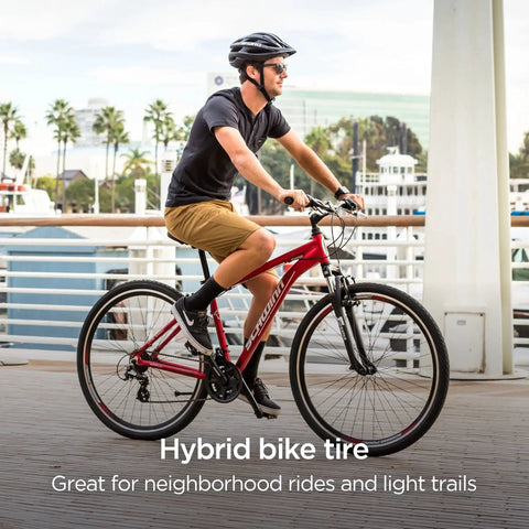 Cyclist riding bike with Replacement 700c x 38 Hybrid Bike Tire With Puncture Guard on a pavement path