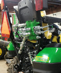 Installed hydraulic quick-connect manifold with 1/4 in NPT ISO 7241-B couplers and dust caps on green tractor