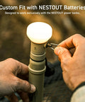 Go-To Rugged Outdoor Camping LED Lantern With Mini Tripod Dimmable USB Powered Soft Light IP44 Weatherproof in beige held outdoors