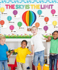 Children in front of 3D Hot Air Balloon Bulletin Board Set With Totally Colorful Name Tags For Back To School Classroom Decor Motivational The Sky Is The Limit Cutouts Cloud Borders And DIY Wall Art Kit