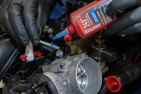 Applying Medium Strength Surface Insensitive Threadlocker For 1/4 To 3/4 Inch Fasteners on automotive engine bolt