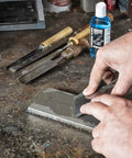 Sharpening chisel with an All In One Pro Grade Diamond Sharpening Kit With 180 600 and 300 1000 Grit Diamond Stones on workbench