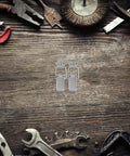 Nickel Plated Spring Loaded Duckbill Toggle Latches Set for cabinets and toolboxes on wooden surface with tools