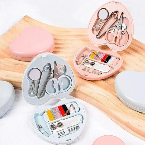 Compact Travel Sewing Kit Two Pack Featuring Adorable Heart Shaped Cases Pink And Blue with scissors, threads, and pins.