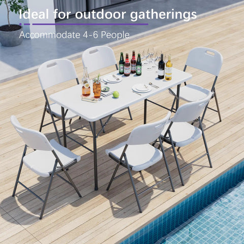 Heavy Duty 4 Foot Folding Table With Carry Handle And Mesh Bag Indoor Outdoor Portable Table For Picnic, Party, Camping, White, Folds In Half, Lightweight Yet Sturdy For Any Event set with drinks and chairs by poolside.