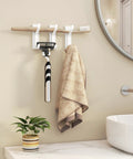 Heavy Duty Adhesive Wall Coat Hooks Four Pack with towels and razor in bathroom over sink next to plant