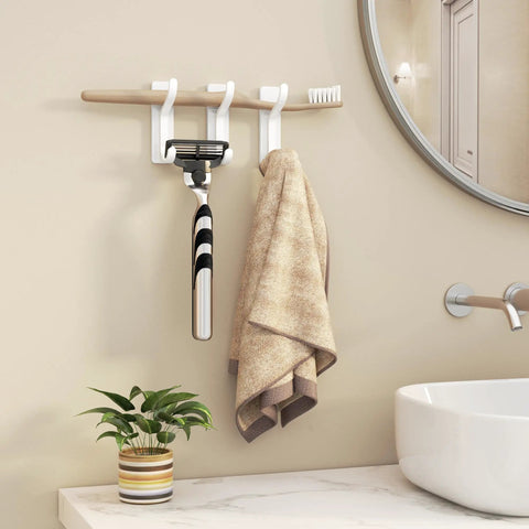 Heavy Duty Adhesive Wall Coat Hooks Four Pack with towels and razor in bathroom over sink next to plant