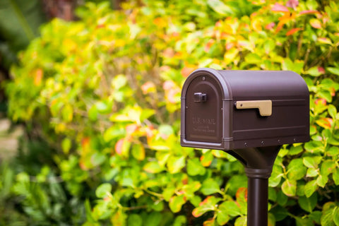 Roxbury Weather Resistant Steel Mailbox With Post Rubbed Bronze Finish Medium Curbside Mailbox With Magnetic Latch USPS Approved in garden setting