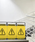 Caution Symbol Foldable Safety Barricade With High Visibility Red Panels, 3 Foot Lightweight Portable Barrier in a stairwell