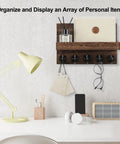 Wall Mounted Key And Mail Organizer With Shelf And Large Hooks For Keys Bags Coats And Leashes Keeps Your Essentials In One Spot Paulownia Wood Key Hanger With Mounting Hardware Brown Finish Durable Entryway Organizer mounted on a wall above a desk with items on shelf.