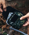 Person using Neoprene Bike Pedal Covers for Transport and Storage, 3mm Thick Cushioned Protection in Green Camouflage design.
