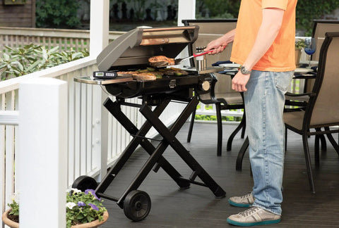 Man grilling on outdoor patio with stainless steel 3 piece BBQ grilling tool set with spatula fork and tongs plus bonus grill glove for outdoor grillin mastery this essential cookout kit makes a killer gift for men dads and real grill lovers