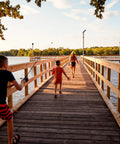 Child with Kids Splash Jr Spincast Reel And Rod Combo Four Foot Two Piece Rod Size Twenty Reel On Lakeside Pier