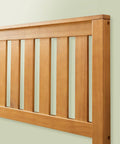 Detail of solid wood slats on the headboard of Top Tier Queen Platform Bed Frame With Tufted Fabric Headboard.