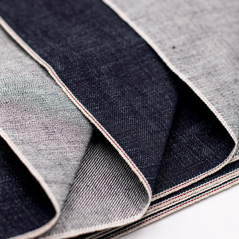 Close-up of 16oz Heavyweight Selvedge Denim Fabric 100 Percent Cotton Raw Indigo Shuttle Loom Woven 35 Inch showing edges.